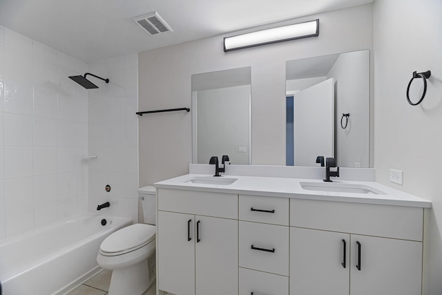 full bathroom featuring toilet, tiled shower / bath combo, tile patterned flooring, and vanity