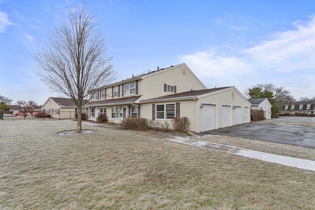 view of front of house featuring a front yard and a garage