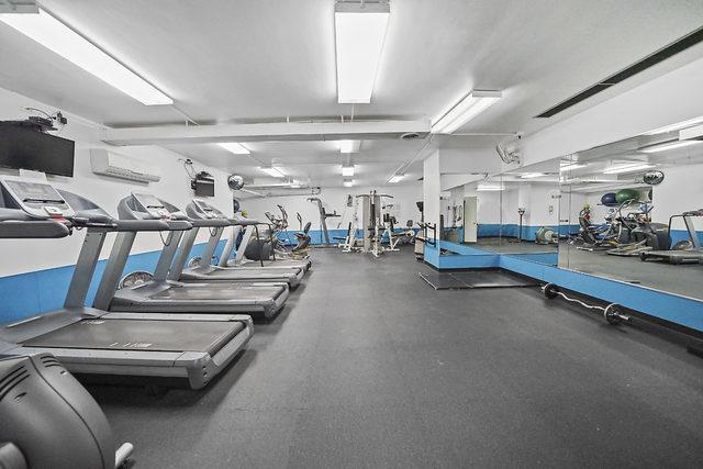 workout area featuring an AC wall unit