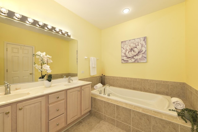 bathroom featuring tile patterned floors, vanity, and a relaxing tiled tub