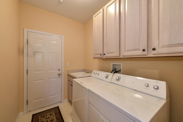 clothes washing area featuring cabinets, independent washer and dryer, and sink