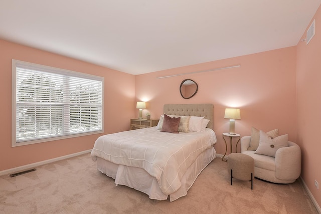 bedroom with light colored carpet