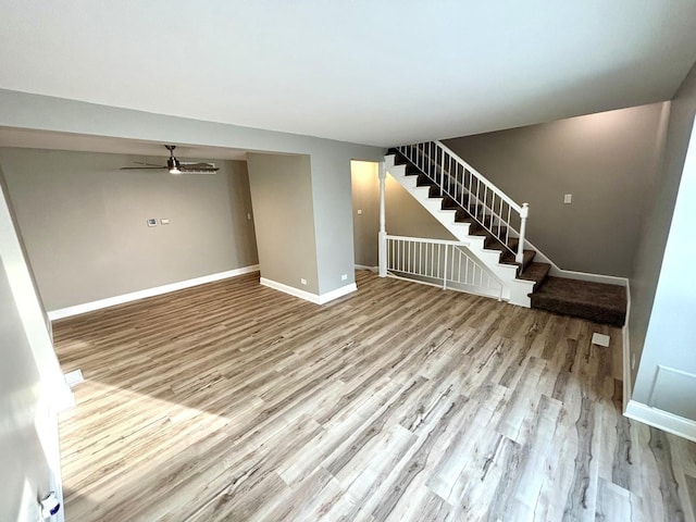 unfurnished living room with light hardwood / wood-style floors and ceiling fan