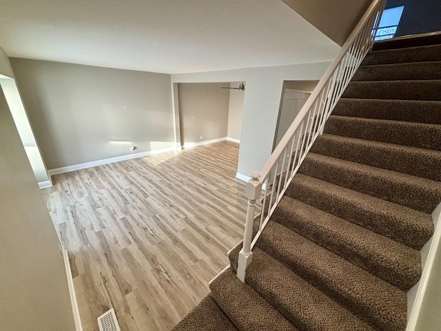 stairway featuring wood-type flooring