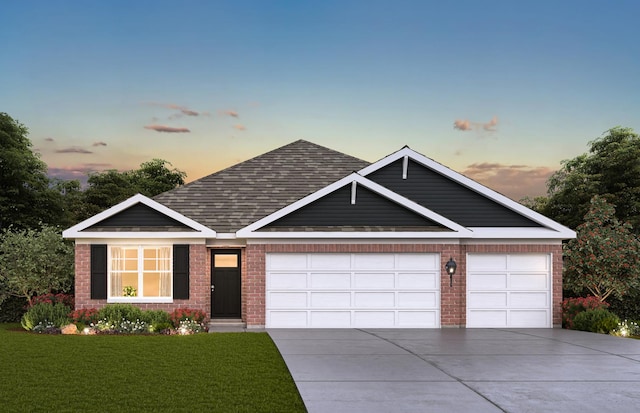 view of front of house with a yard and a garage