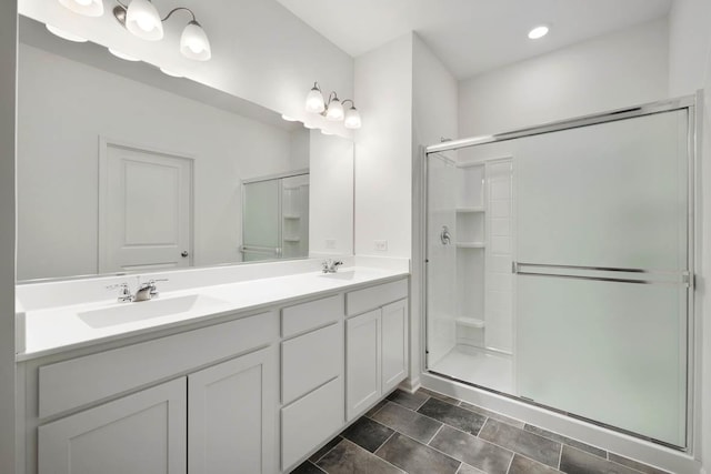 bathroom featuring tile patterned floors, vanity, and a shower with door