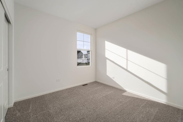 spare room featuring carpet floors