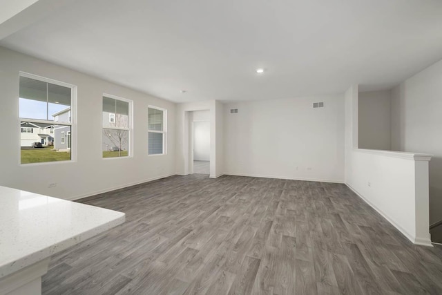 unfurnished living room with dark hardwood / wood-style floors