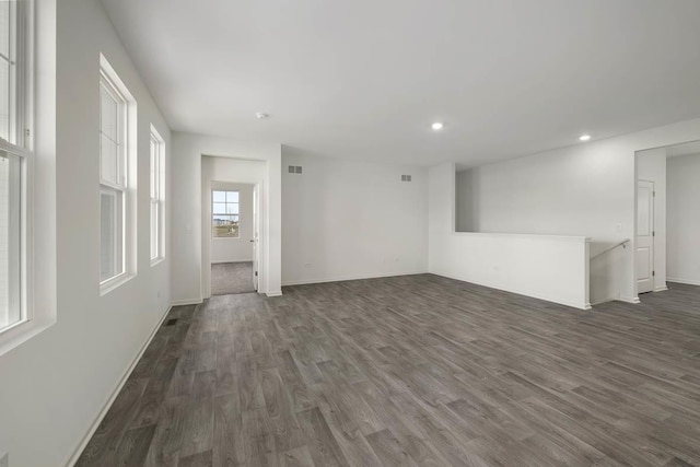 unfurnished living room featuring dark hardwood / wood-style floors