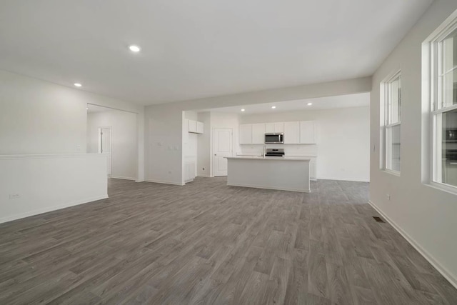 unfurnished living room with dark hardwood / wood-style floors