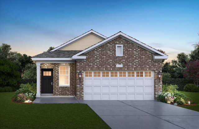 front facade featuring a lawn and a garage