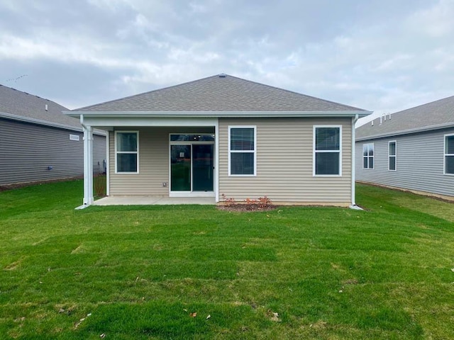 back of house featuring a lawn and a patio area