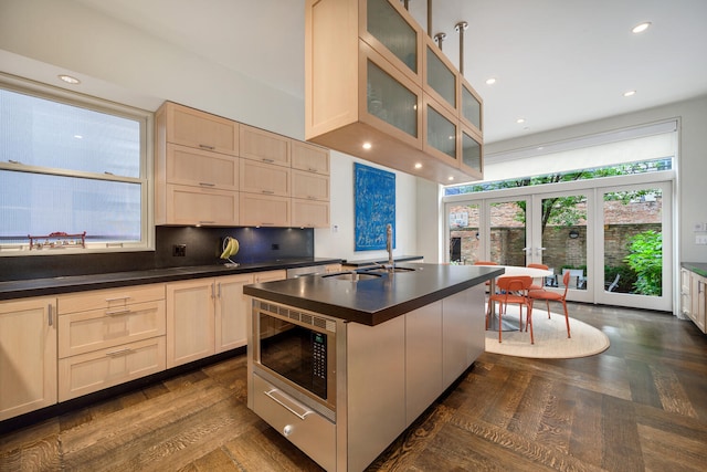 kitchen featuring built in microwave, french doors, sink, tasteful backsplash, and dark hardwood / wood-style floors