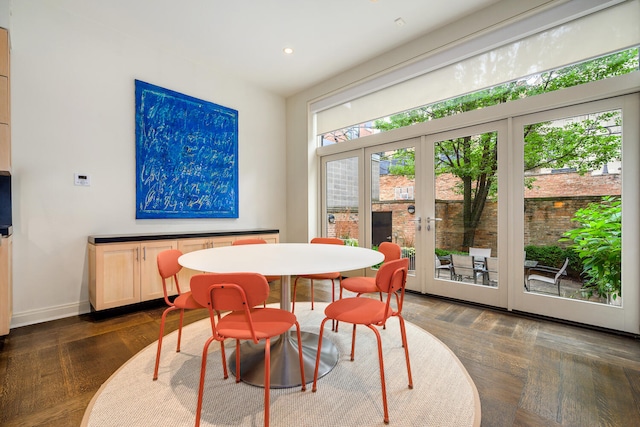 dining area with dark hardwood / wood-style flooring and french doors