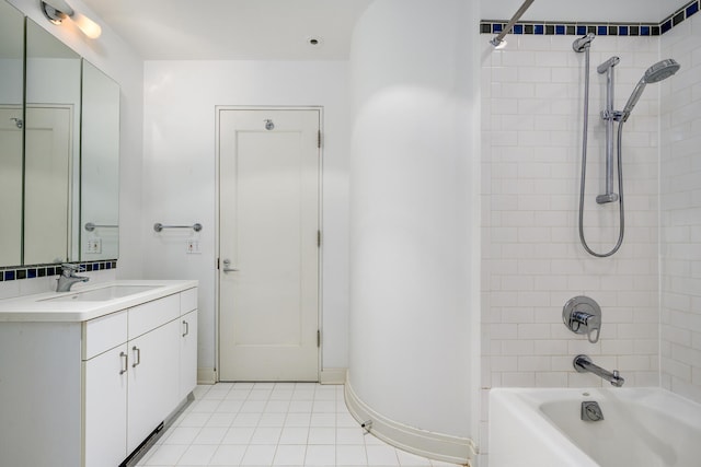 bathroom featuring tile patterned floors, vanity, and tiled shower / bath