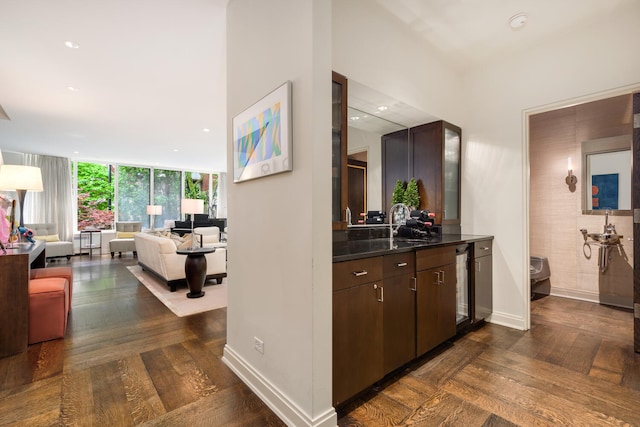 corridor with floor to ceiling windows and sink