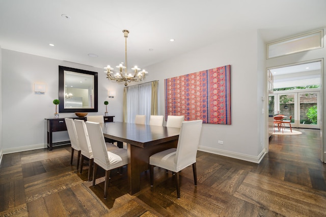 dining area with dark parquet floors and a notable chandelier