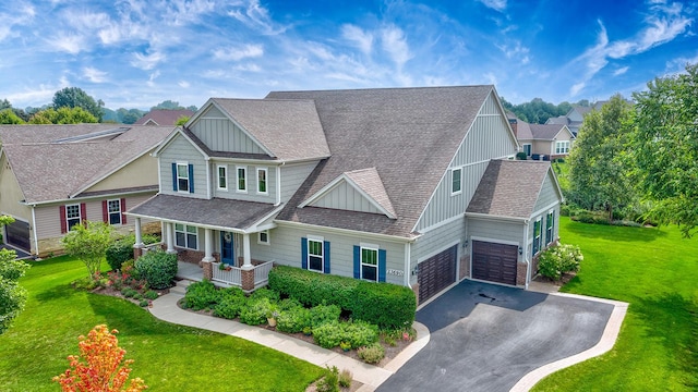 craftsman inspired home with a front lawn, a porch, and a garage