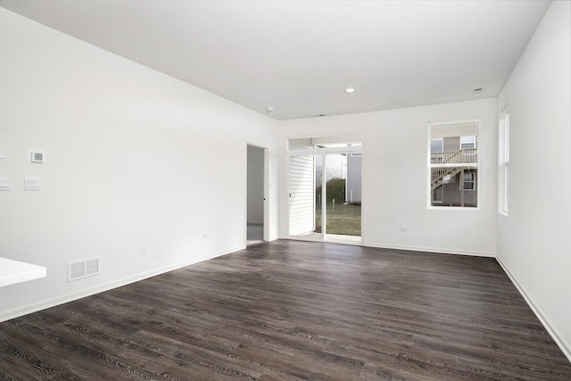 unfurnished room with dark hardwood / wood-style flooring