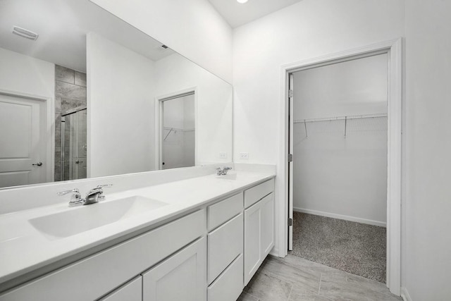 bathroom featuring vanity and an enclosed shower