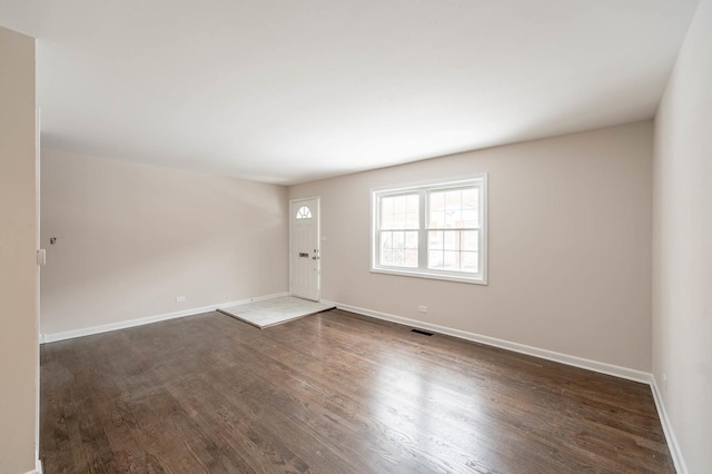 empty room featuring dark wood-type flooring