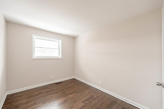 spare room with dark hardwood / wood-style flooring