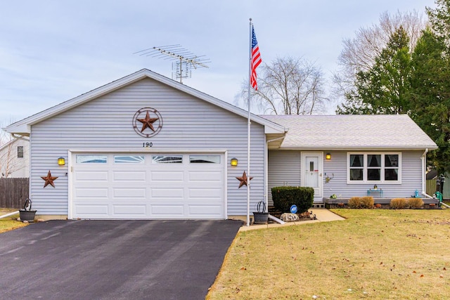 ranch-style home featuring a garage and a front yard