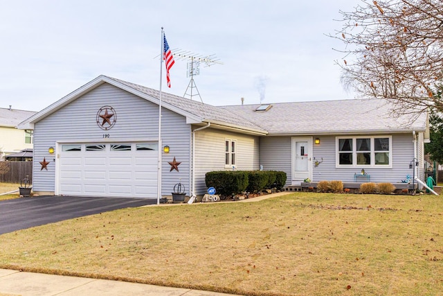 ranch-style home featuring a garage and a front lawn