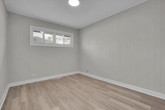 spare room featuring light hardwood / wood-style floors