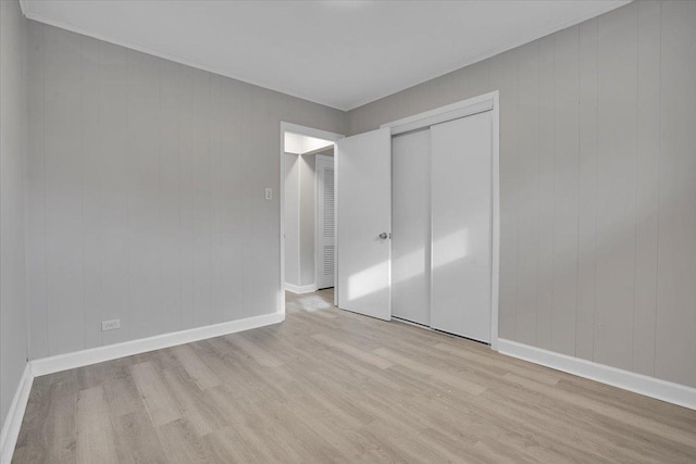 unfurnished bedroom featuring a closet and light hardwood / wood-style flooring