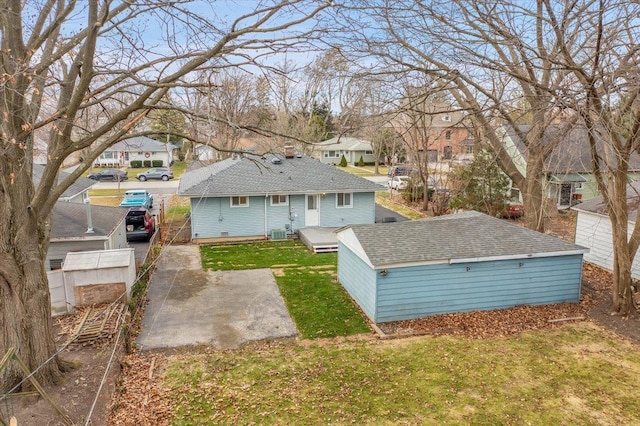 back of house with a yard and central AC unit