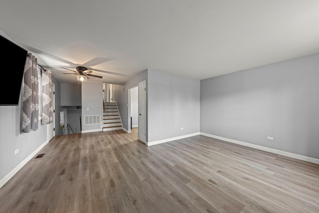 unfurnished living room with ceiling fan and light hardwood / wood-style flooring