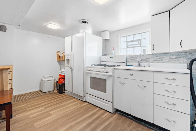 kitchen with white cabinets, sink, tasteful backsplash, light hardwood / wood-style floors, and white range with gas stovetop