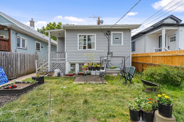 rear view of property with a lawn