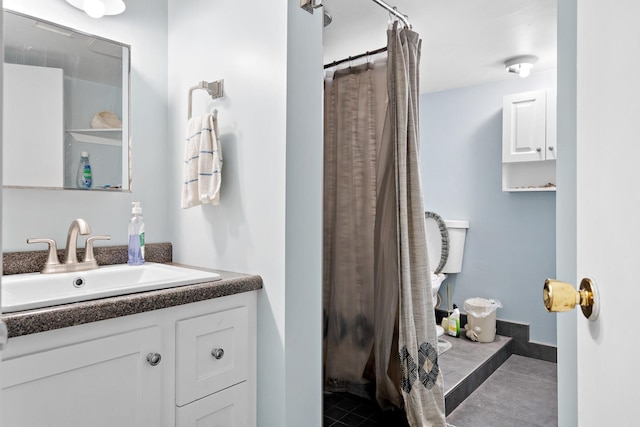 bathroom featuring tile patterned flooring, vanity, and curtained shower