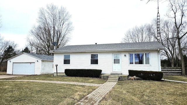 view of front of house with an outbuilding, a front yard, and a garage