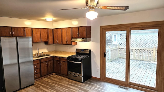 kitchen featuring sink, wood-type flooring, ceiling fan, and appliances with stainless steel finishes