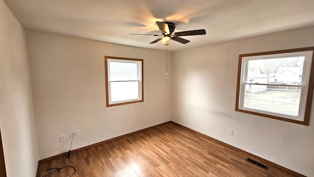 unfurnished room with ceiling fan and light wood-type flooring