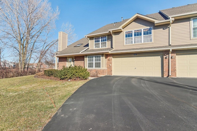 view of front facade featuring a front yard and a garage