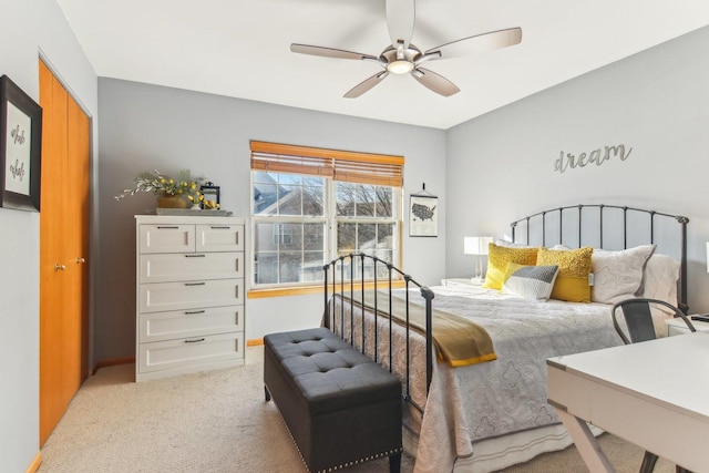 bedroom featuring ceiling fan, light carpet, and a closet