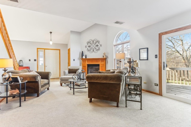 living room with light colored carpet and lofted ceiling