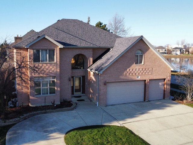 view of property with a water view and a garage