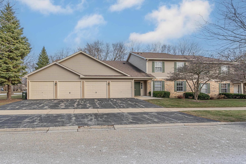 view of front facade featuring a garage and a front lawn