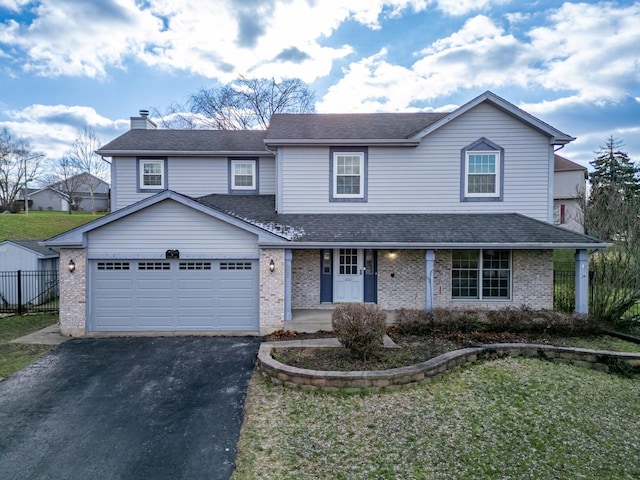 view of front of house with a porch, a garage, and a front lawn