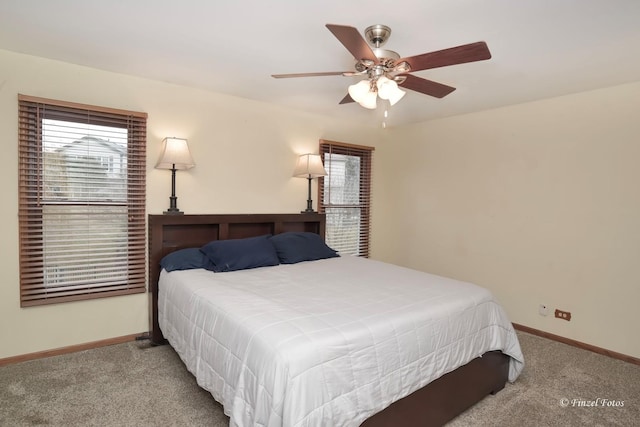 bedroom featuring multiple windows, ceiling fan, and light colored carpet