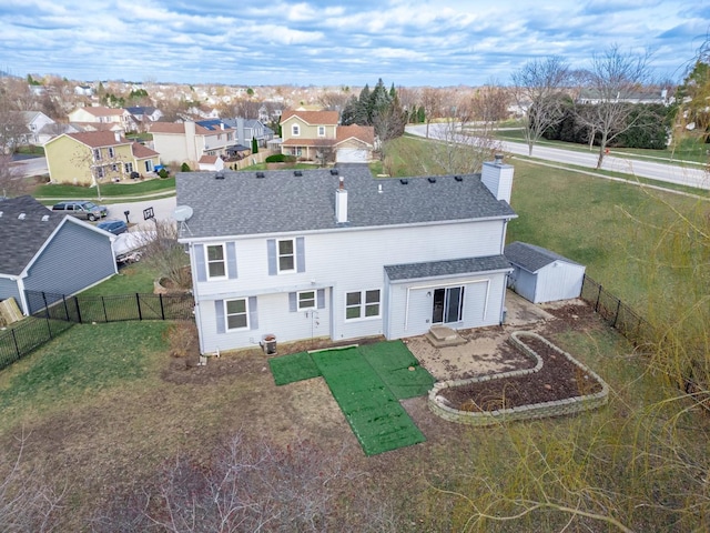 back of property featuring a patio area and a yard