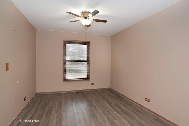 spare room featuring wood-type flooring and ceiling fan