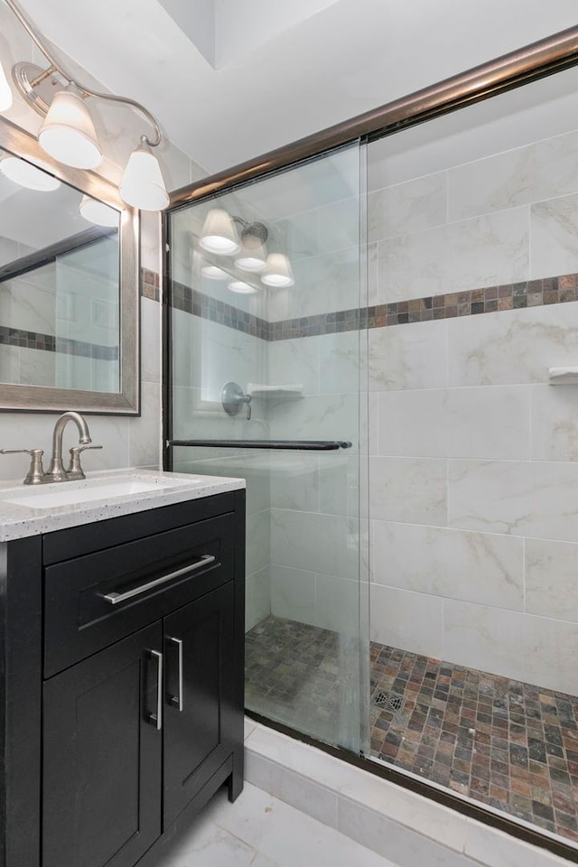 bathroom featuring vanity and an enclosed shower