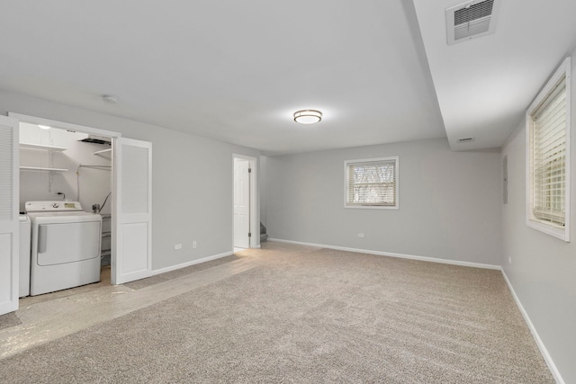 interior space featuring separate washer and dryer and light carpet