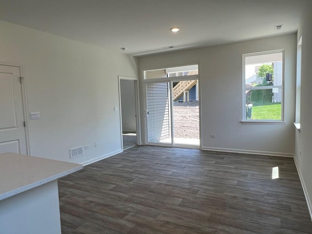 unfurnished dining area with dark hardwood / wood-style flooring